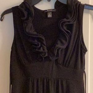 Black dress ruffle around the neck.